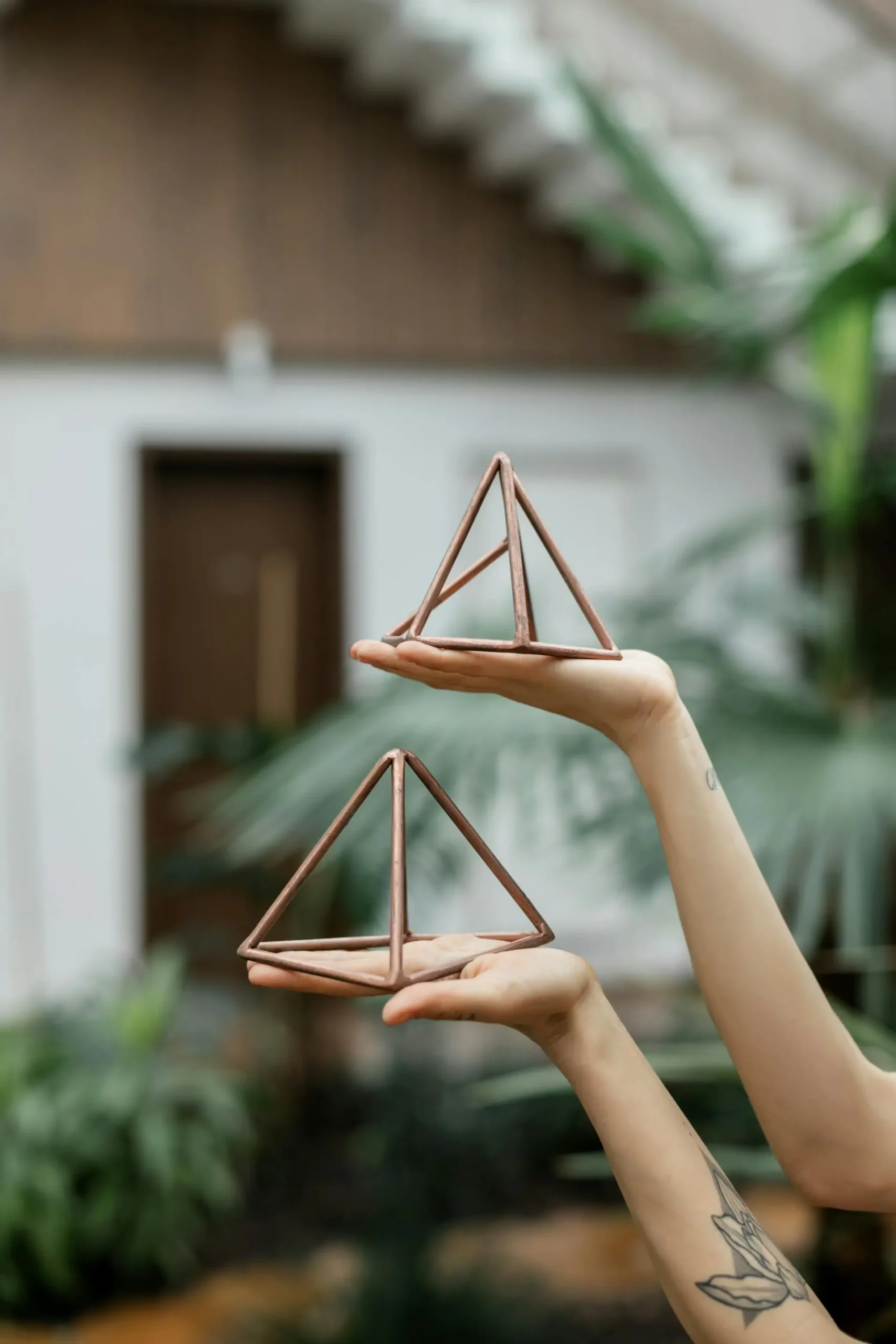 Hands Holding Pyramids